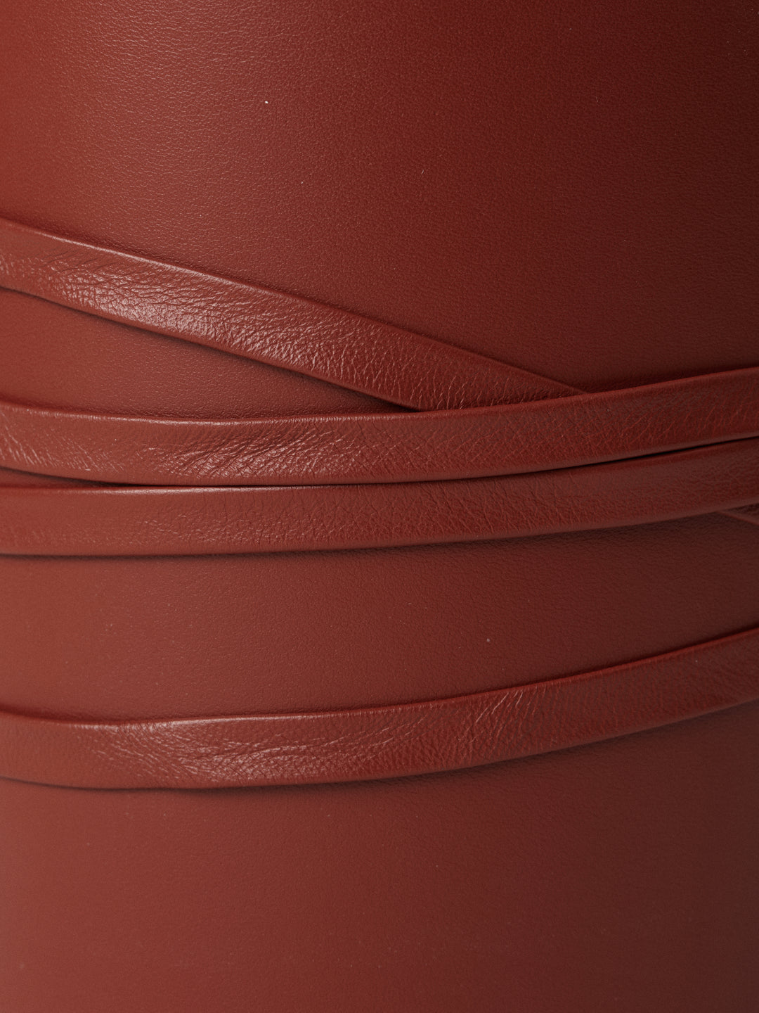 Close-up of Déhanche Undone Corset in brown leather, highlighting the intricate wrap design and fine texture details.