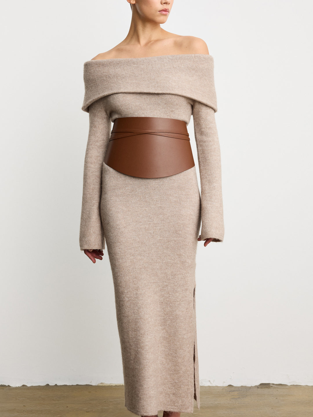Déhanche undone leather corset in brown, styled with beige off-shoulder dress. Elegant and chic fashion statement for women.