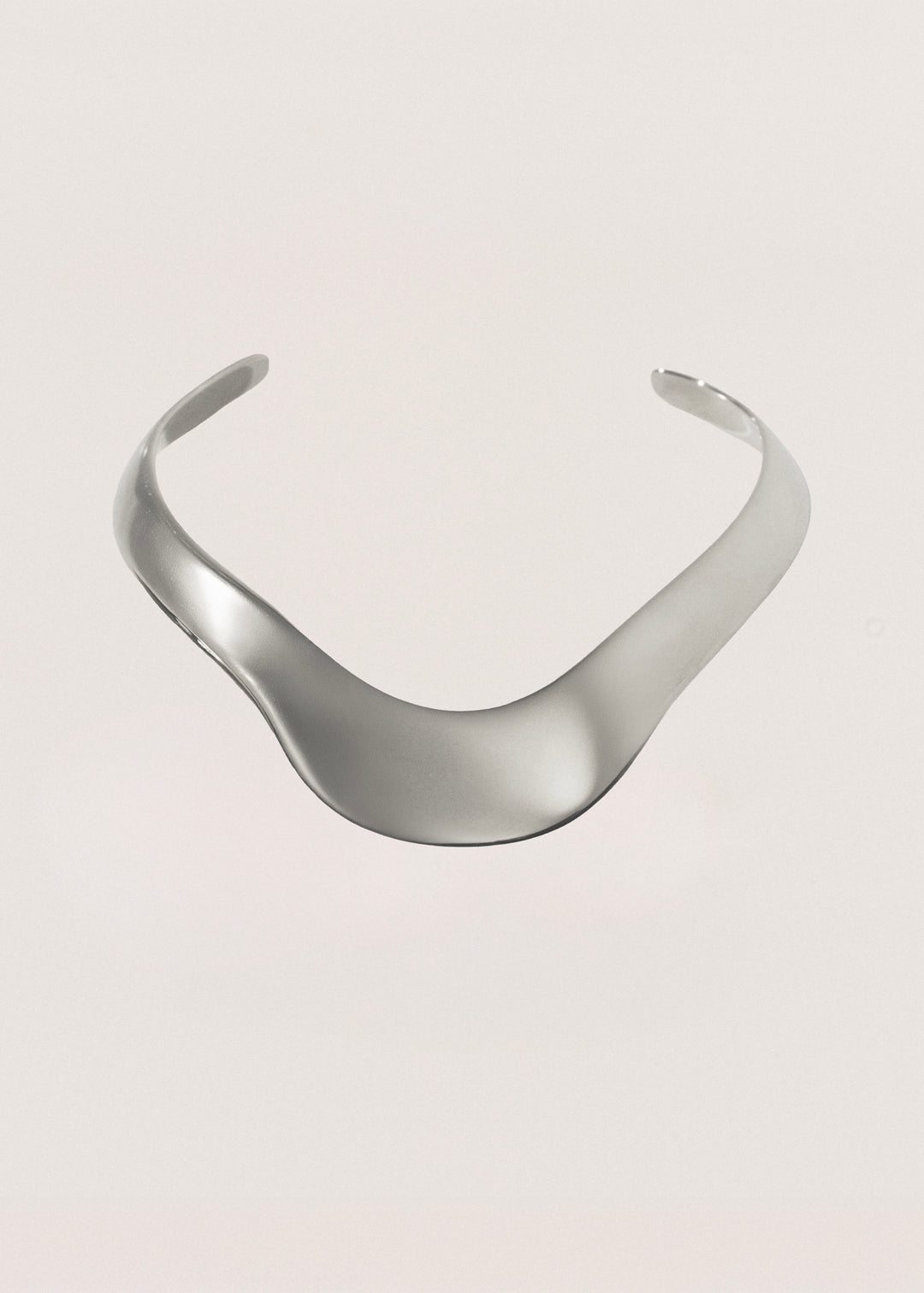 Silver choker on a light gray background