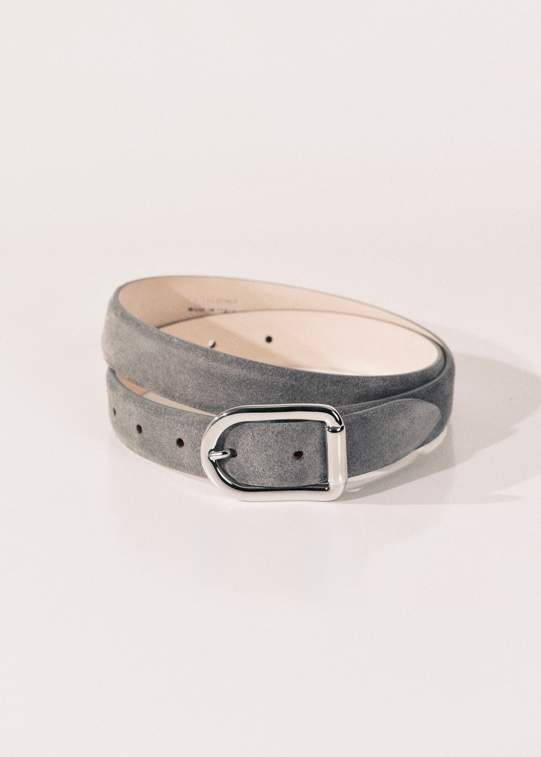 A gray suede belt with a silver-tone metal buckle. 