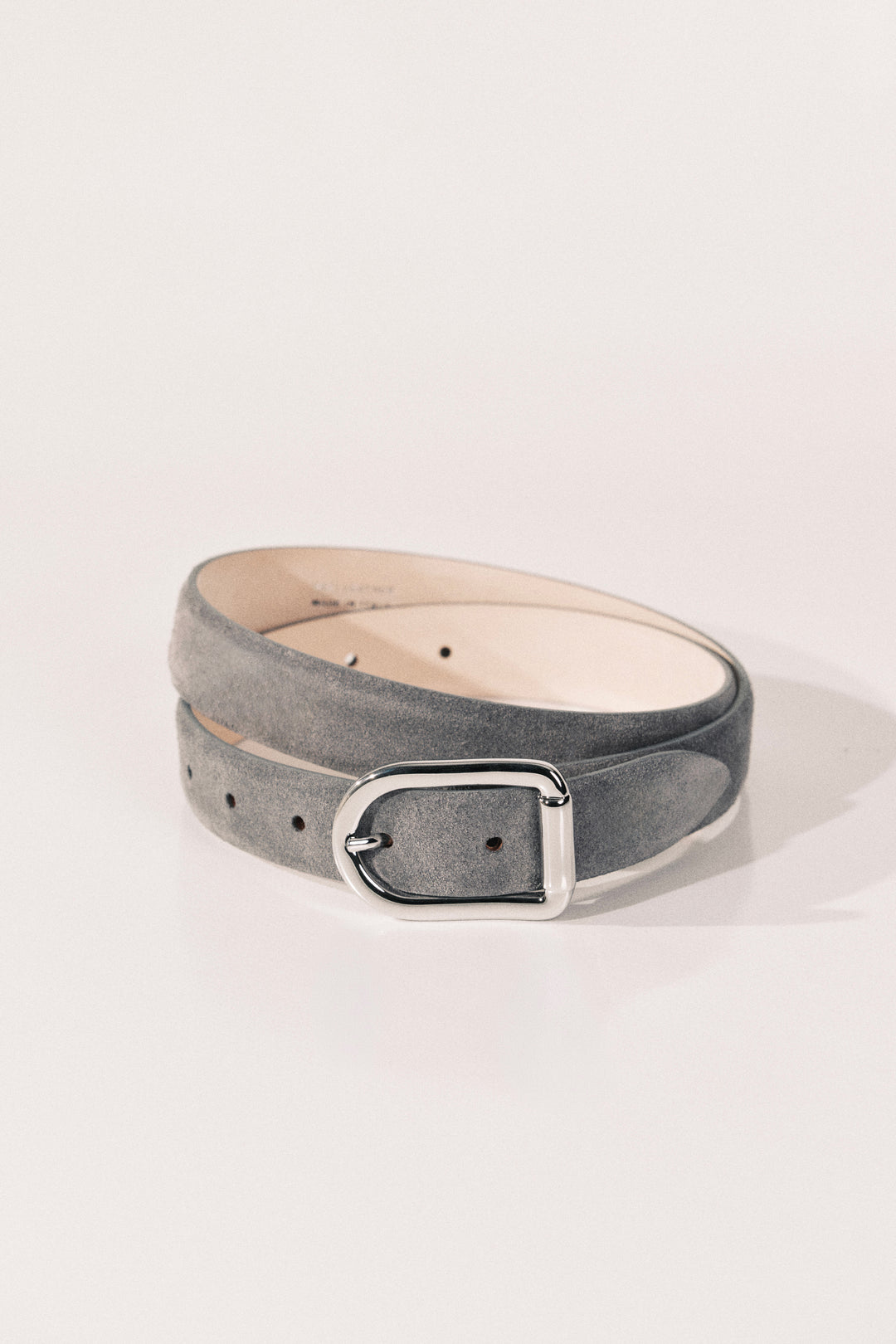 A gray suede belt with a silver-tone metal buckle. 