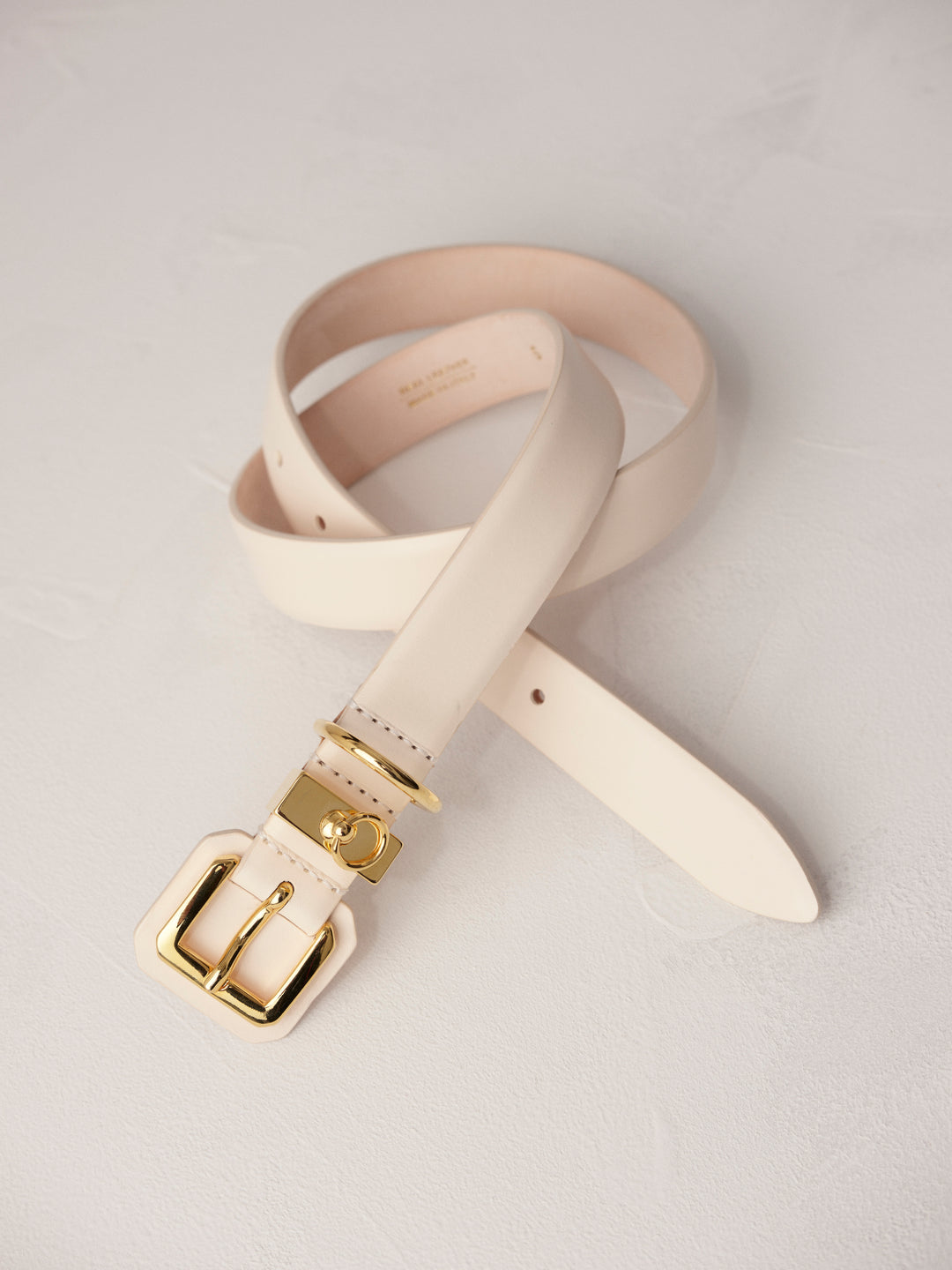 Elegant and stylish women's fashion accessory. High-quality and chic statement piece. Italian sourced leather. Calfskin suede. Silver hardware. 24k gold. Luxury. Déhanche.