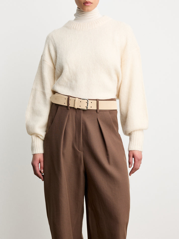Déhanche Hutch Suede Belt - Stylish natural beige suede belt paired with a cream sweater and brown high-waisted pants, showcasing the belt's elegant and versatile look.