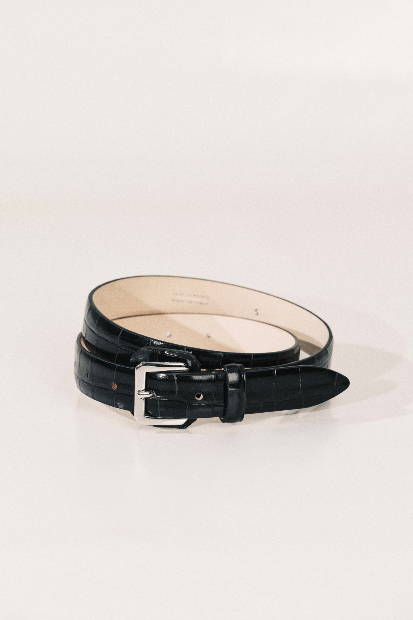 A black alligator belt with a silver-tone buckle. 