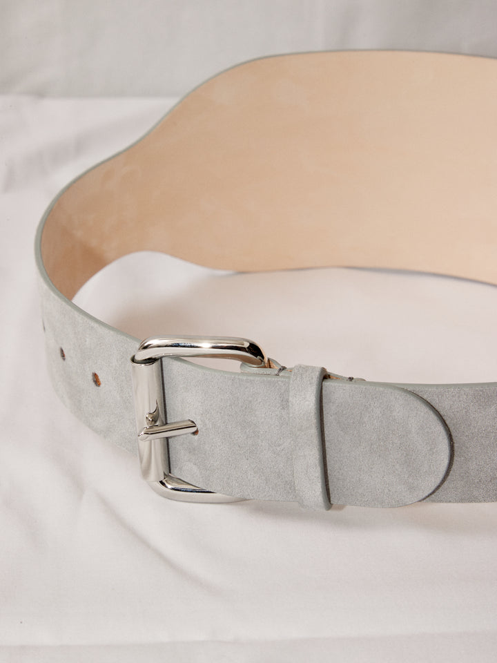 Déhanche boleyn wide grey suede belt with silver buckle. Elegant and stylish women's fashion accessory. High-quality and chic statement piece.