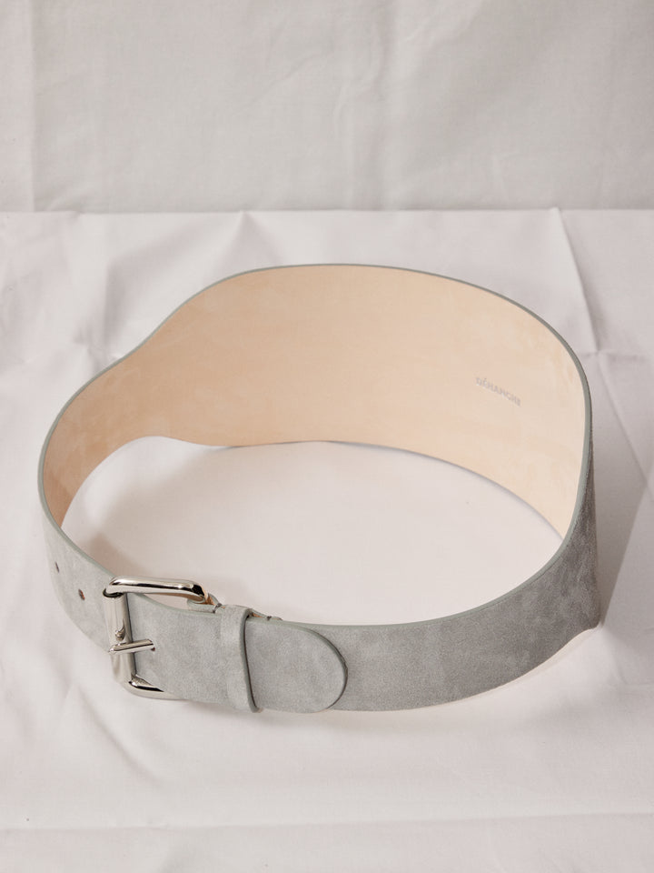 Déhanche boleyn wide grey suede belt with silver buckle. Elegant and stylish women's fashion accessory. High-quality and chic statement piece.