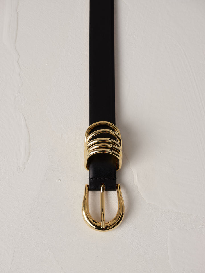 Déhanche Hollyhock Gold Belt - Elegant black leather belt with a gold buckle and accents. Perfect for adding a touch of sophistication to any outfit.