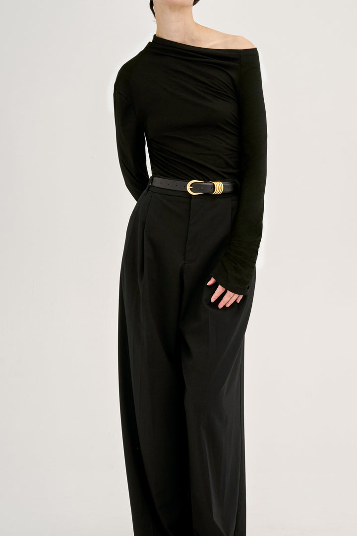 Déhanche hollyhock gold asymmetrical black top and wide-leg pants. Stylish women's fashion outfit with black belt and gold detail. High fashion outfit.