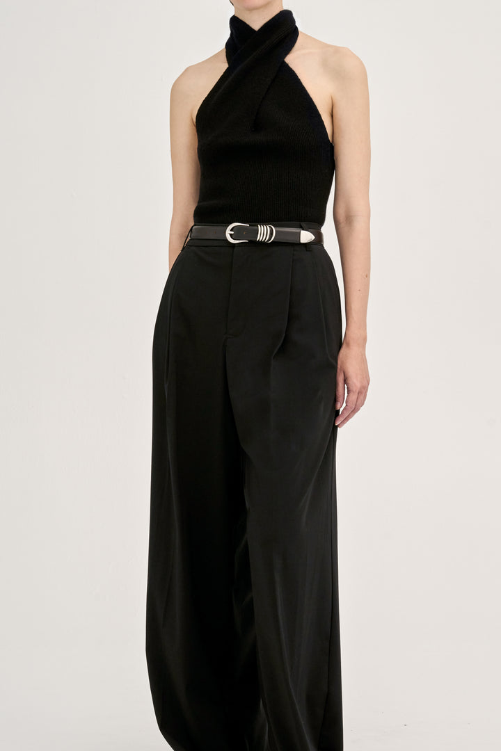 Déhanche hollyhock halter black top and wide-leg pants. Elegant and stylish women's fashion outfit with a silver belt accent. High fashion statement.