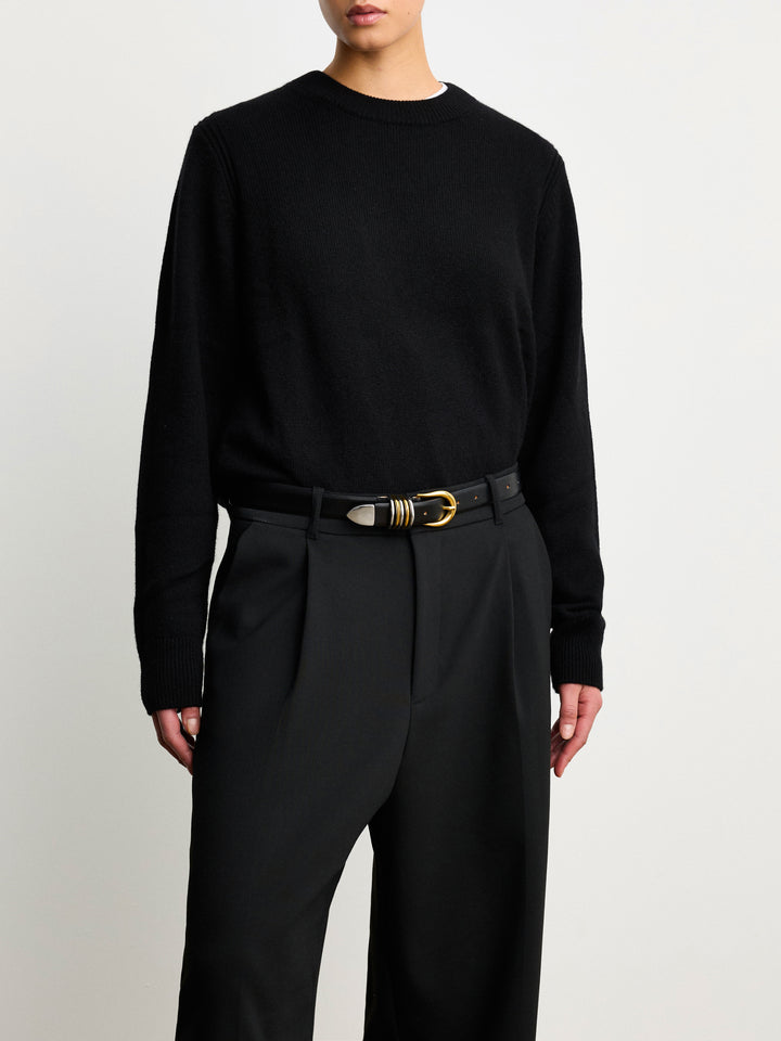 Déhanche Hollyhock Mixed Metal Belt - Stylish black leather belt with a mixed metal gold and silver buckle, worn with black trousers and a black sweater. Perfect for a sophisticated look.