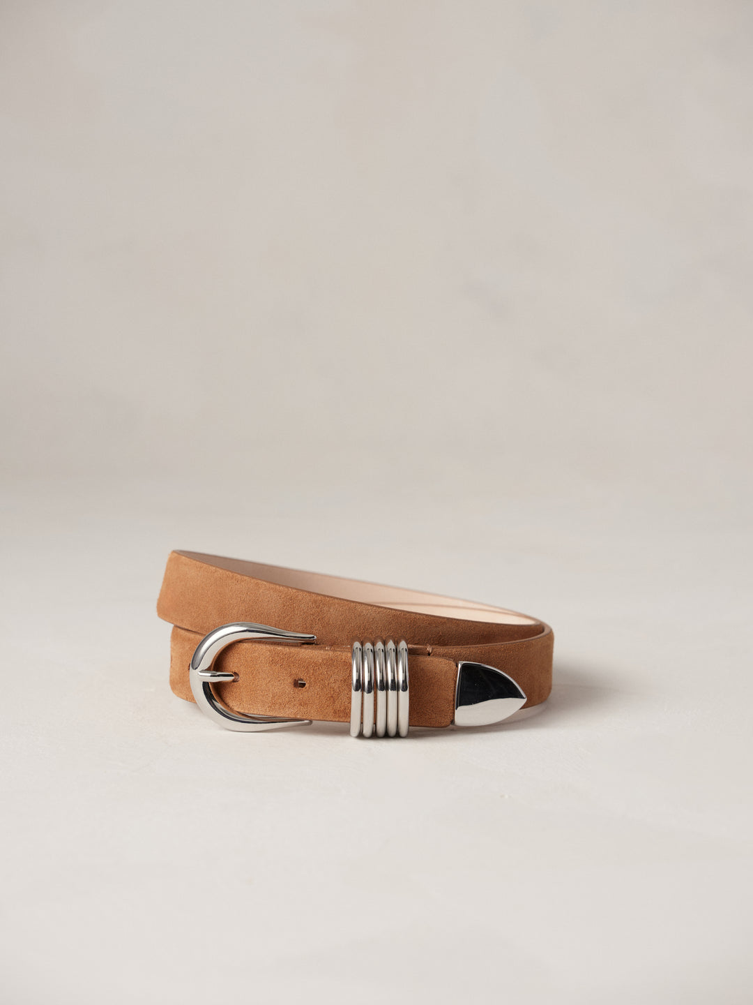 Déhanche Hollyhock Suede Belt - Elegant brown suede leather belt with silver buckle and accents. Perfect for adding a touch of classic sophistication to any outfit.