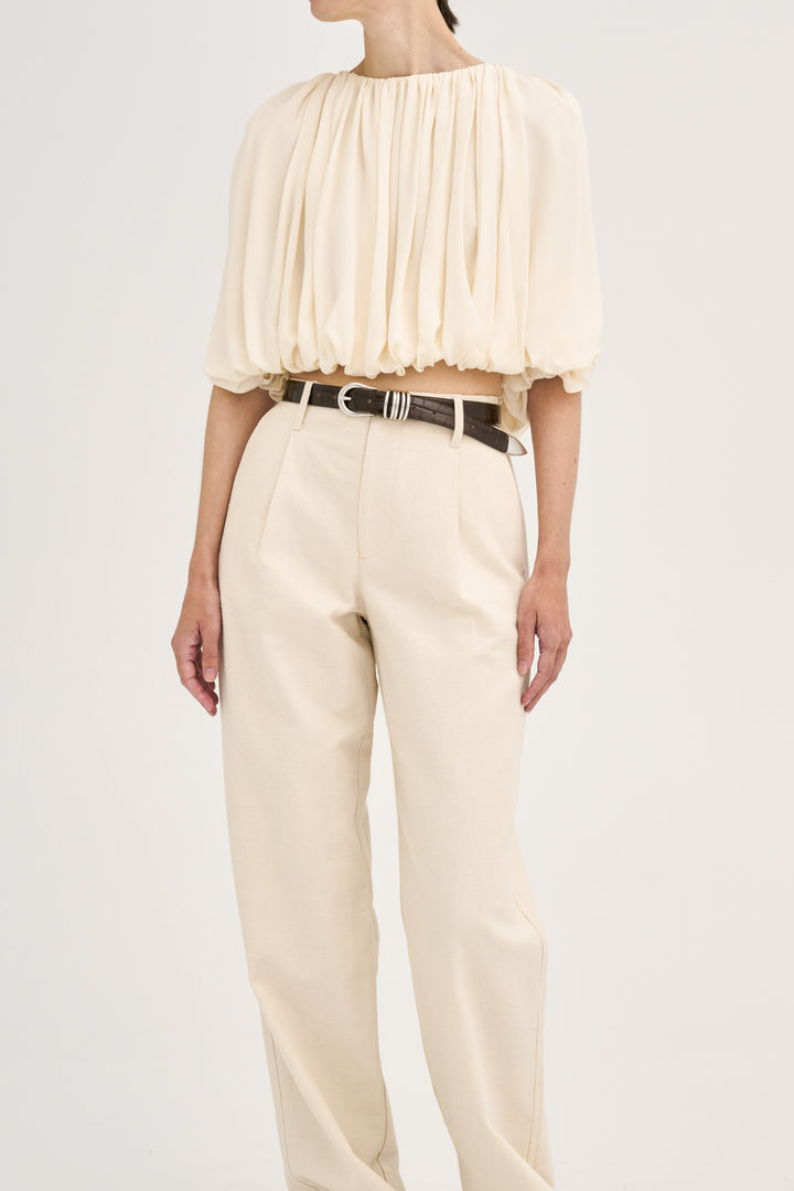 Déhanche hollyhock croco cream puff sleeve blouse and high-waisted pants. Elegant women's fashion outfit with brown croco belt accent.