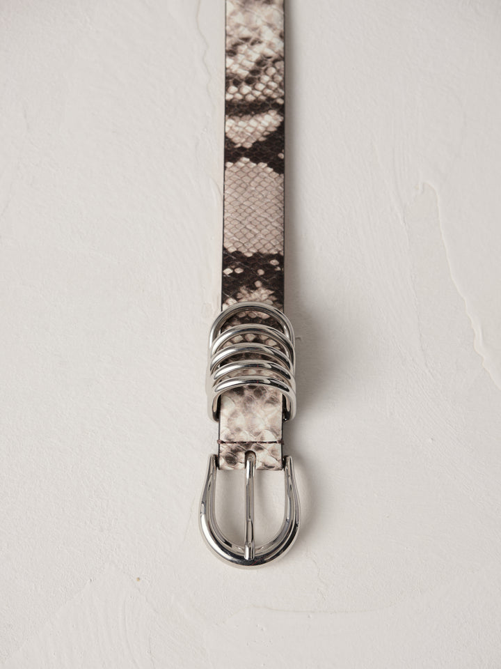 Déhanche Hollyhock Snake Belt - Elegant snake print leather belt with silver buckle and accents. Perfect for adding a bold, sophisticated touch to any outfit.