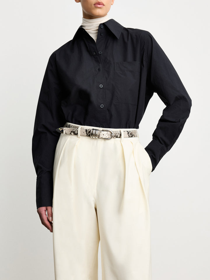 Déhanche Hollyhock Snake Belt - Chic snake print leather belt with silver buckle, paired with a black shirt and cream trousers. Ideal for a bold, sophisticated look.
