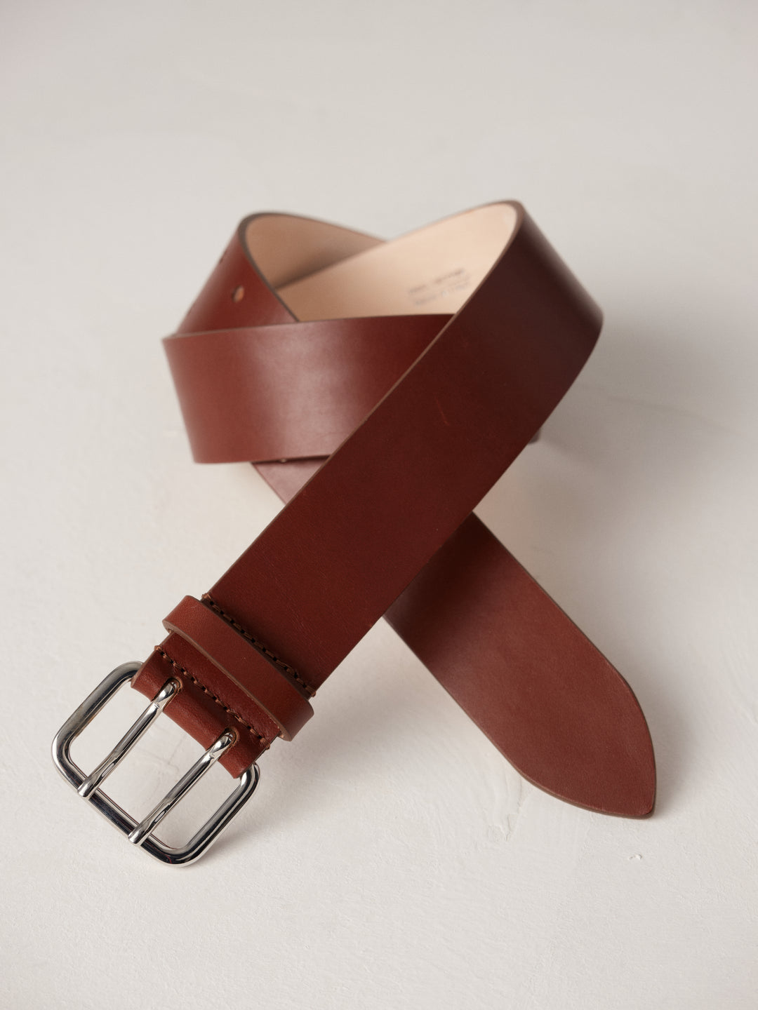 Déhanche Hutch Leather Belt - Classic brown leather belt with a silver buckle. Perfect for adding a touch of timeless elegance to any outfit.