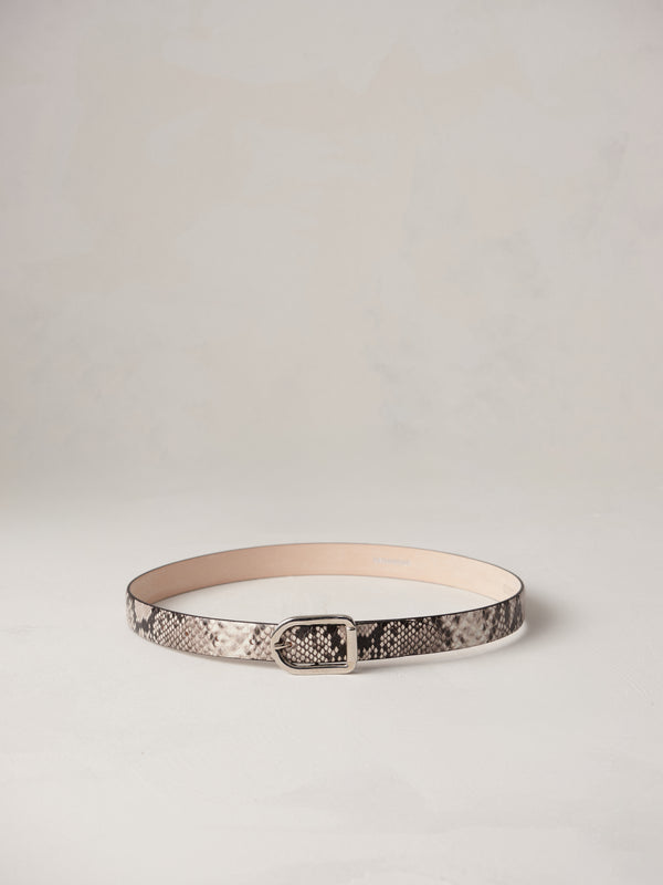 Déhanche Mija Snake embossed leather belt with snake pattern and silver buckle, displayed against a light background.