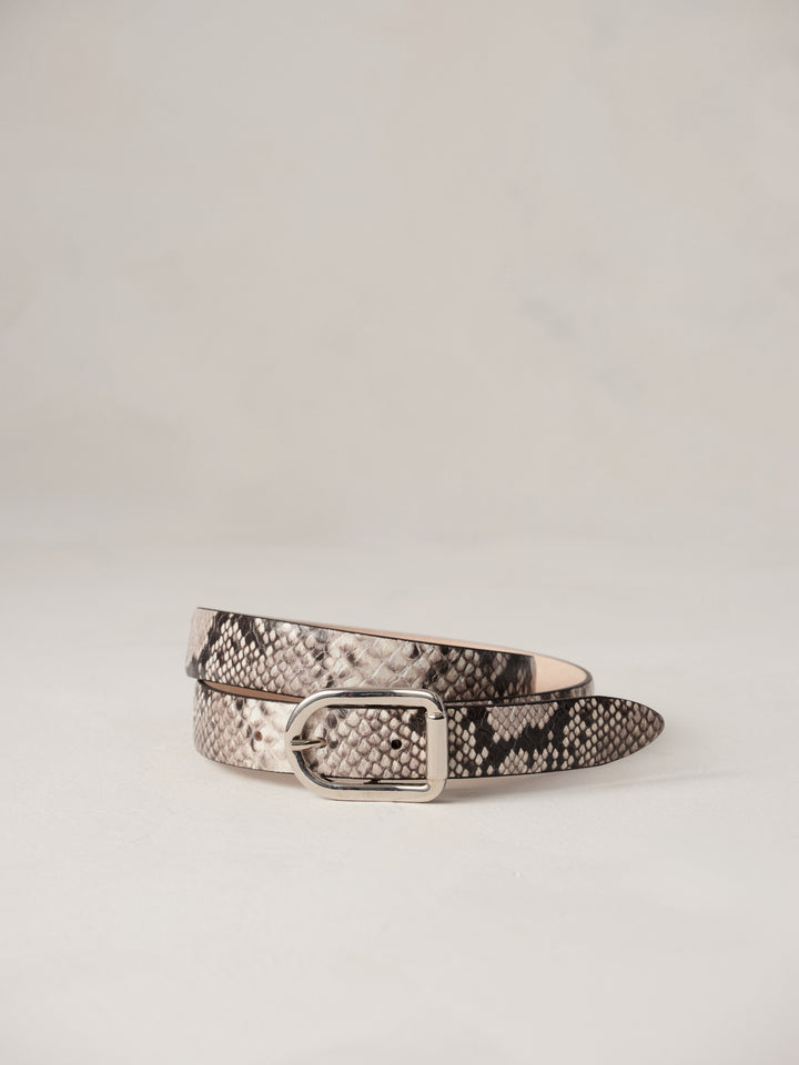 Déhanche Mija Snake embossed leather belt with snake pattern and silver buckle, displayed against a light background.