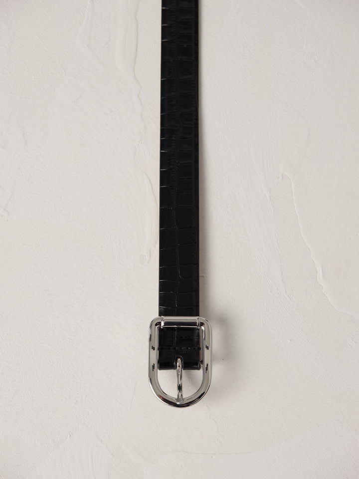 Déhanche Mija Croco black leather belt with crocodile texture and silver buckle, displayed against a light background.