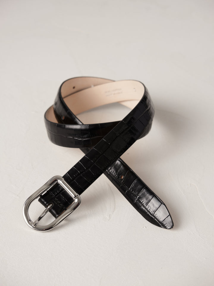 Déhanche Mija Croco black leather belt with crocodile texture and silver buckle, displayed against a light background.