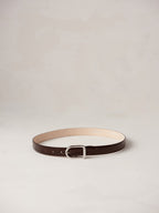 Déhanche Mija Croco brown leather belt with crocodile texture and silver buckle, displayed against a light background.