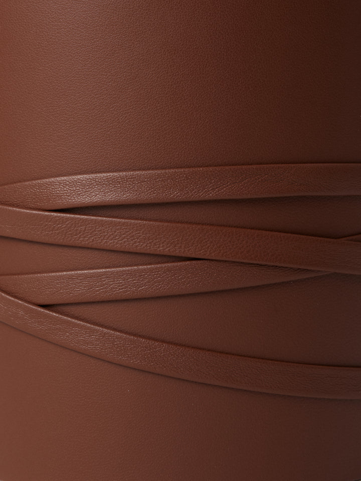 Close-up of Déhanche undone brown leather corset. Fine details and craftsmanship. Stylish and elegant waist accessory for women.