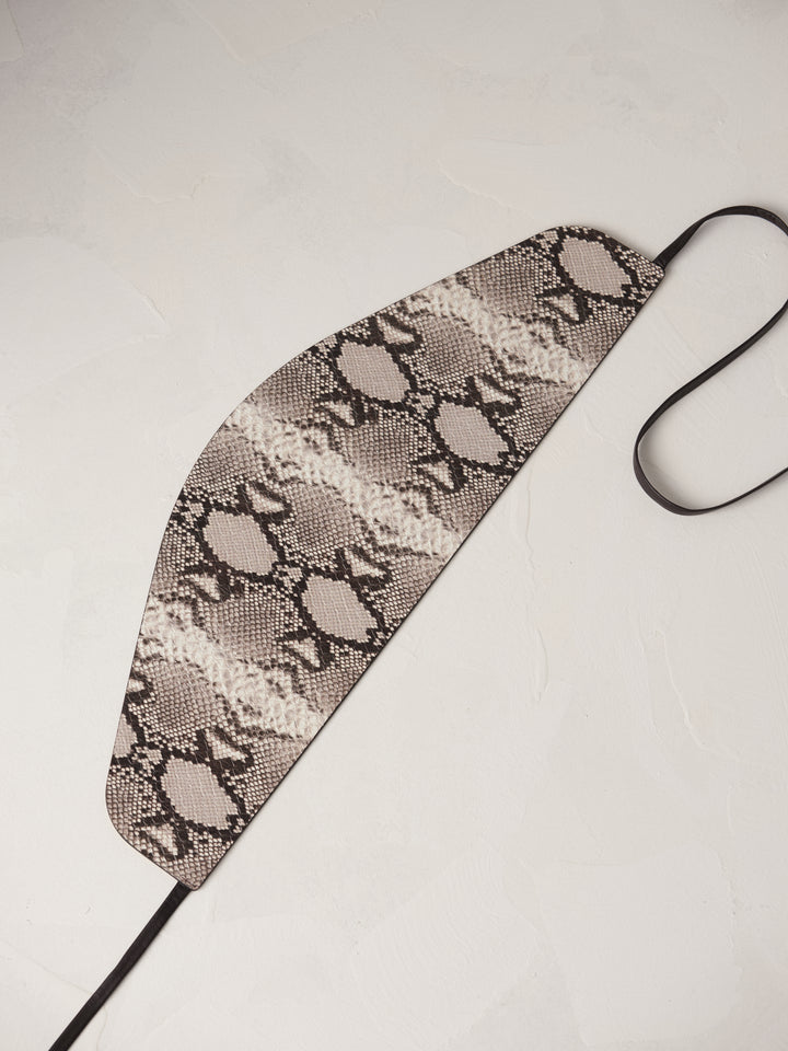 Déhanche undone corset snake, flat view in snake print leather. Versatile and stylish fashion accessory for women.