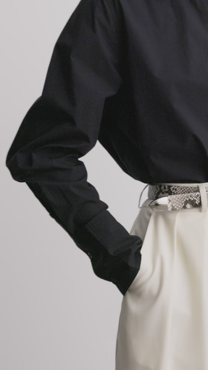 Déhanche Hollyhock Snake Belt - Chic snake print leather belt with silver buckle, paired with a black shirt and cream trousers. Ideal for a bold, sophisticated look.