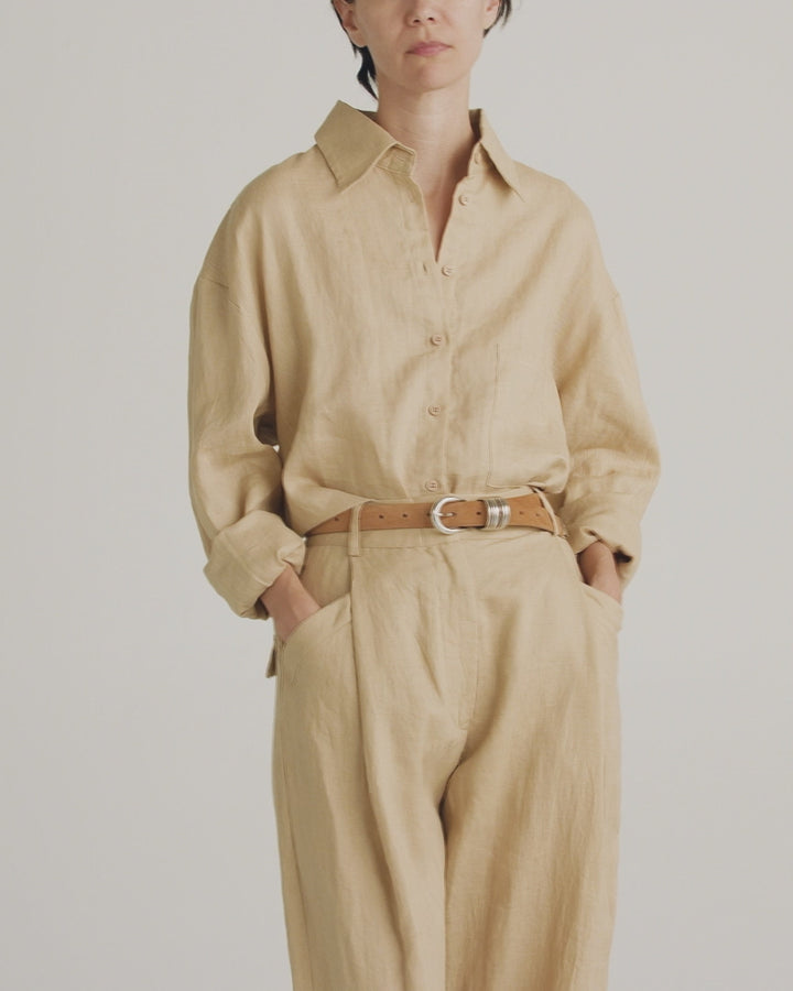Déhanche Hollyhock Suede Belt - Chic brown suede leather belt with silver buckle, paired with a beige button-up shirt and trousers. Perfect for a refined, monochromatic look.
