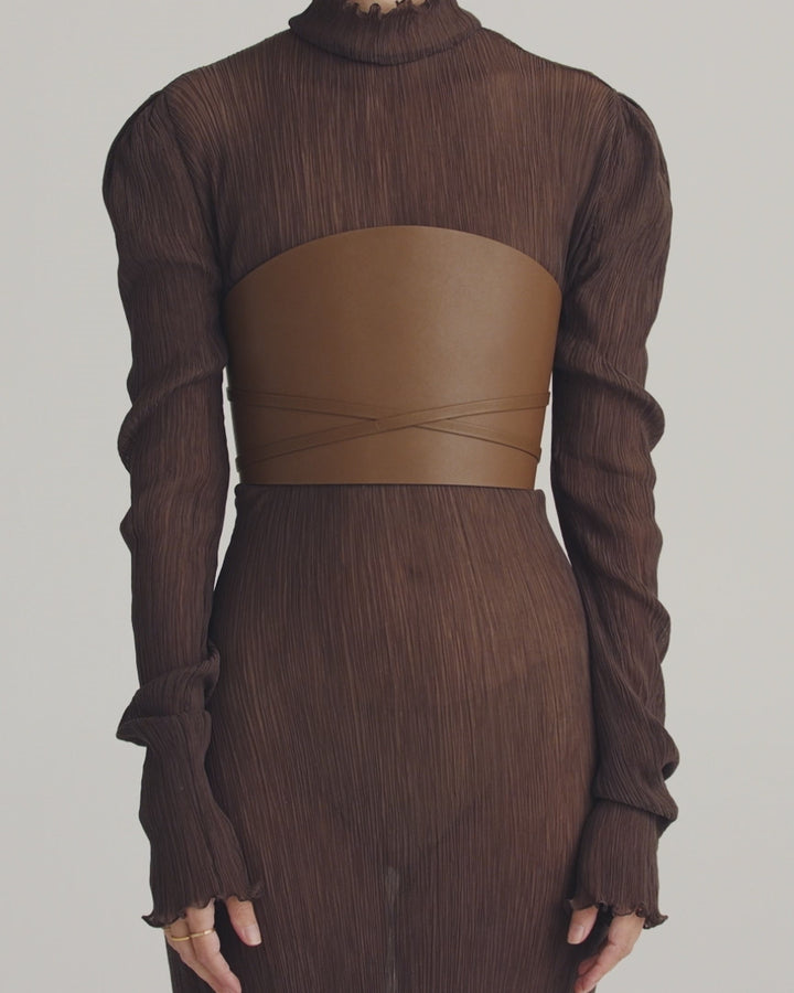 Déhanche undone leather corset in brown, styled with sheer brown dress. Modern and chic fashion accessory for women.