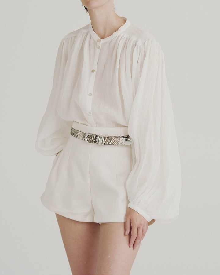 Déhanche Hollyhock Snake Belt - Stylish snake print leather belt with silver buckle, paired with a white blouse and high-waisted shorts. Perfect for a bold, elegant look.